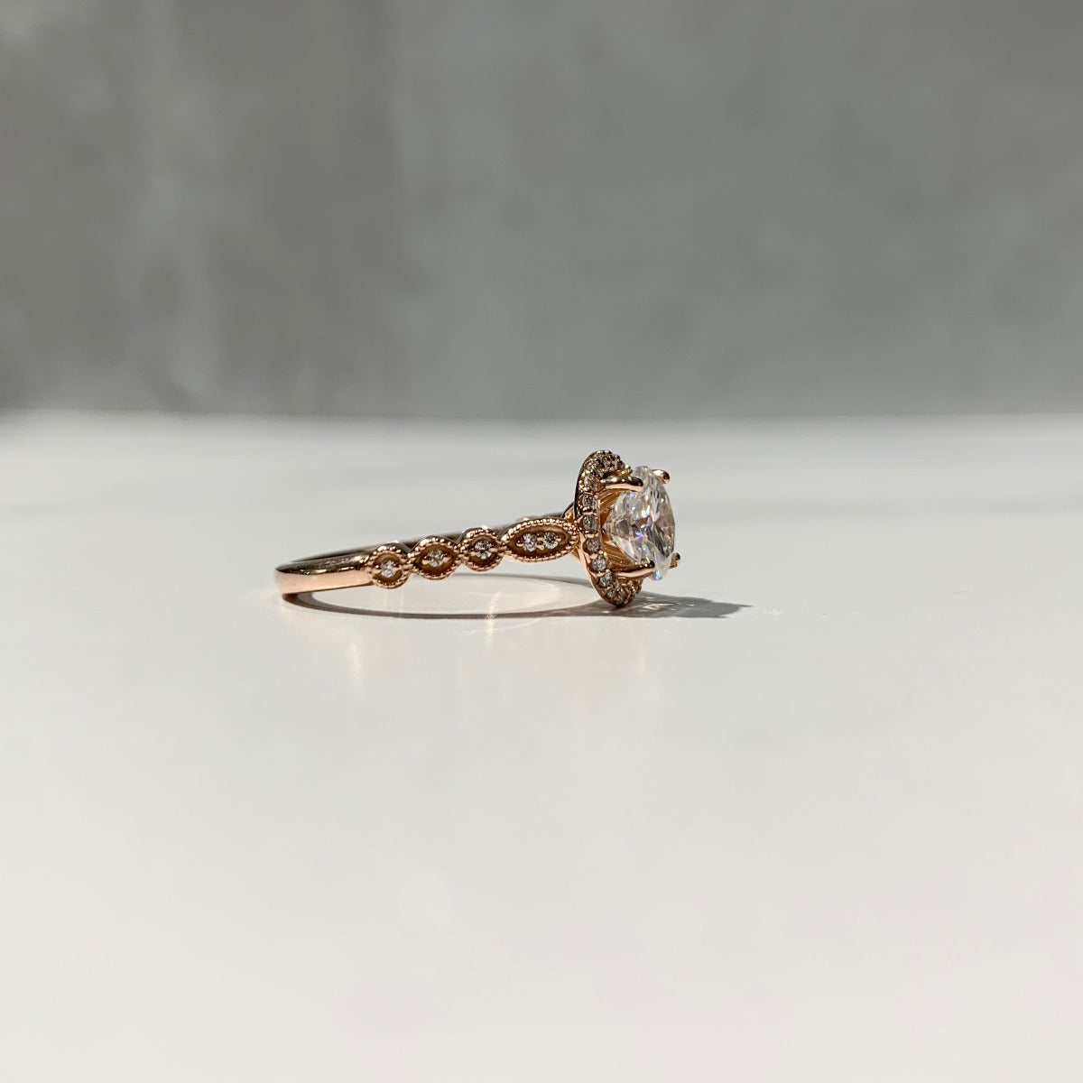 Vintage inspired rose gold halo engagement ring