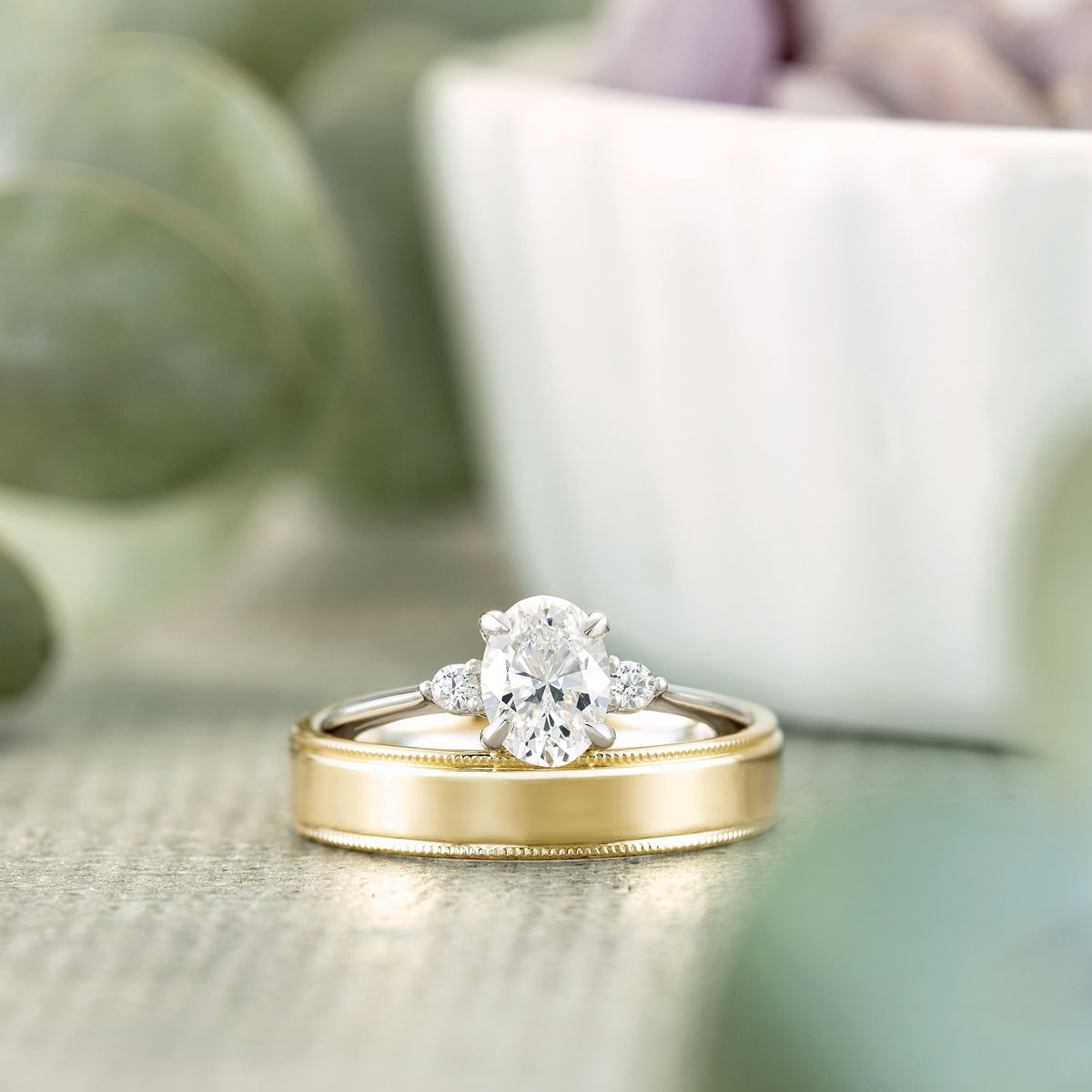 Three-Stone Ring paired with yellow gold wedding band