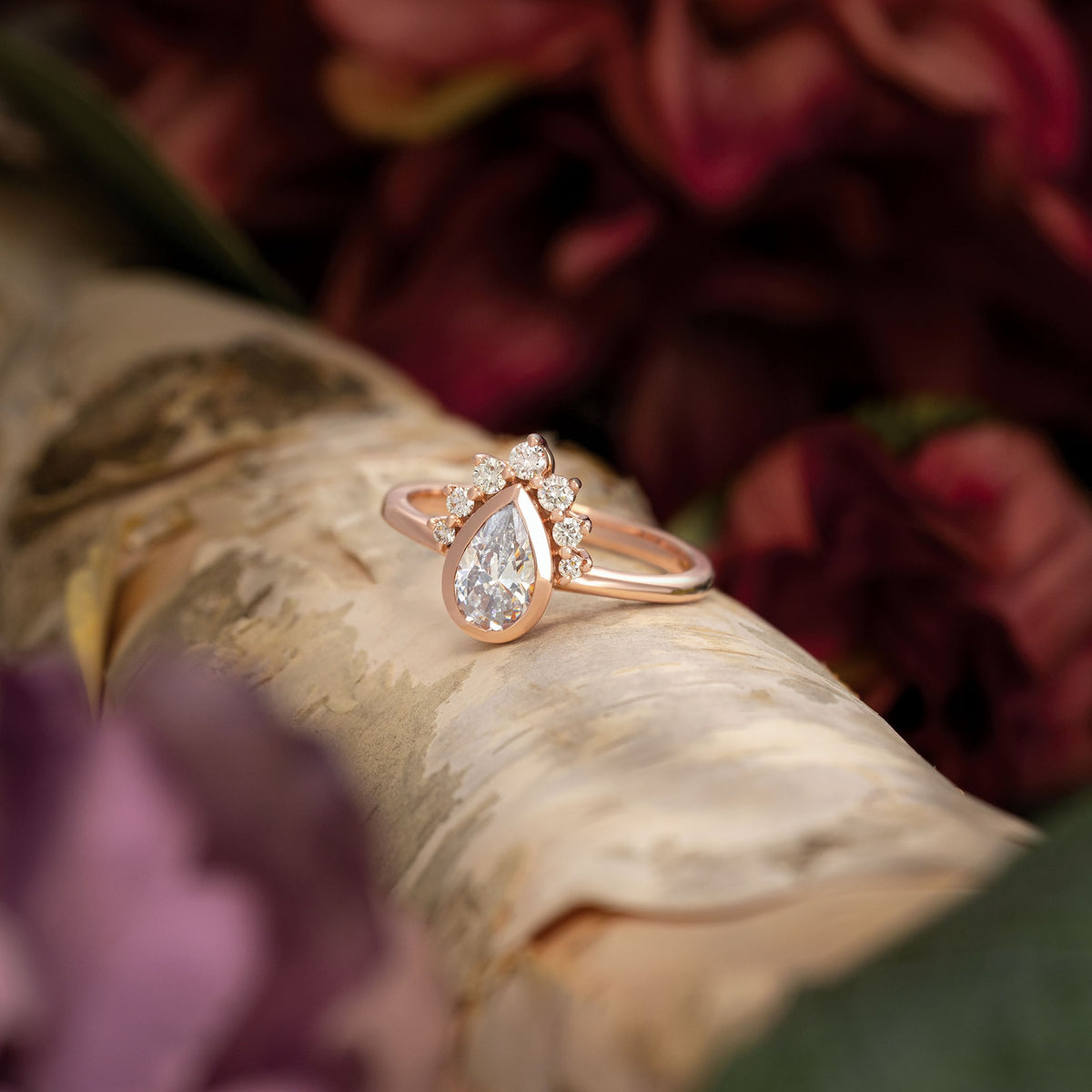 half halo bezel set ring rose gold pear diamond