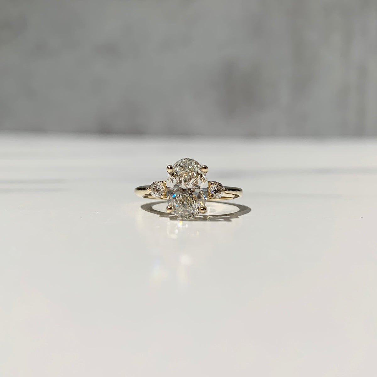 Petite three stone yellow gold engagement ring