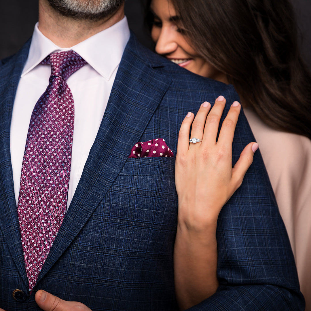 Smiling woman wears three-stone engagement ring